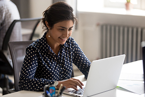 Photo of a woman searching for a job via a laptop.