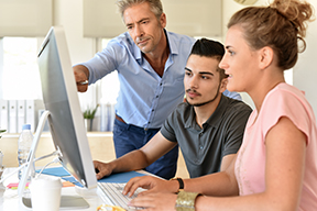 Photo of a banking professional and two interns. 