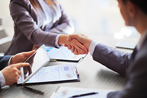 Photo of two people shaking hands. 